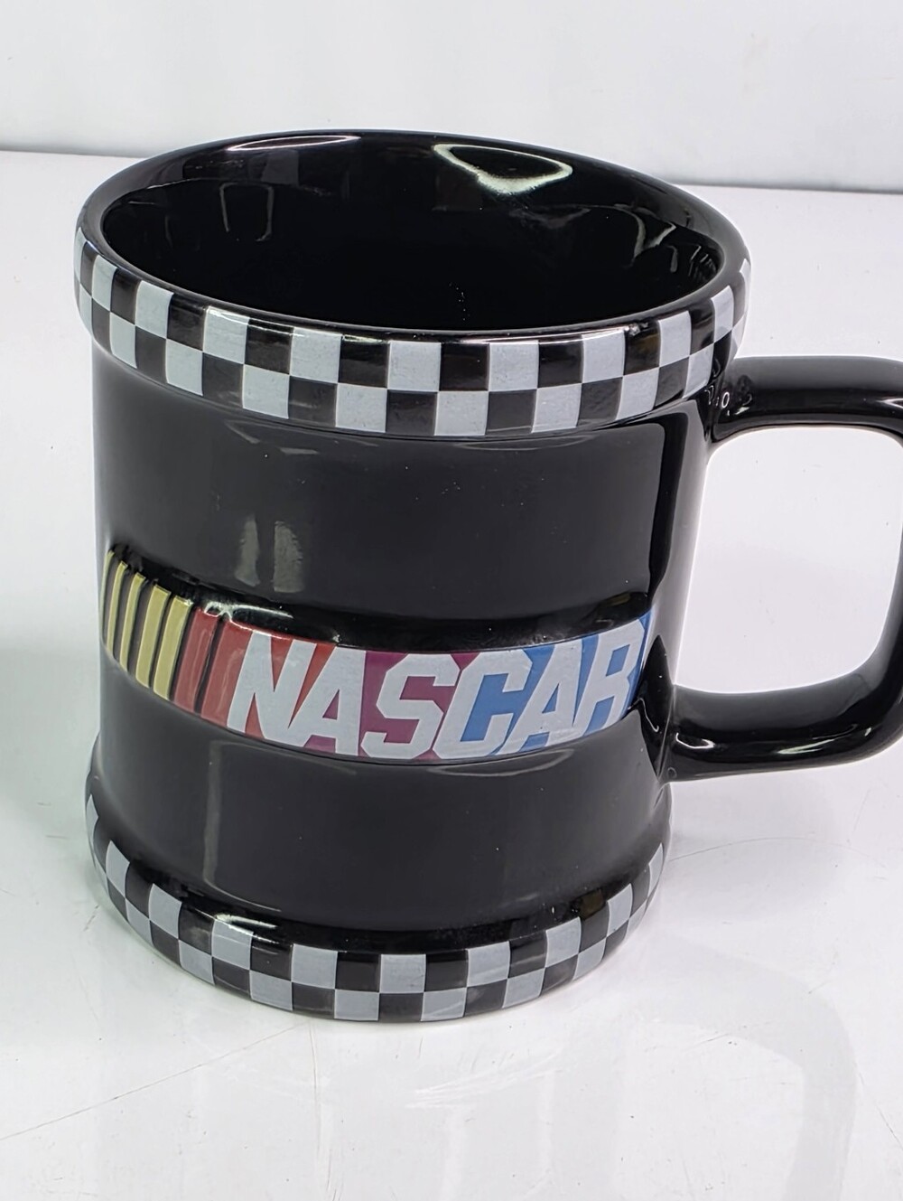 NASCAR Black Ceramic Mug Cup with Checkered Flag Trim.